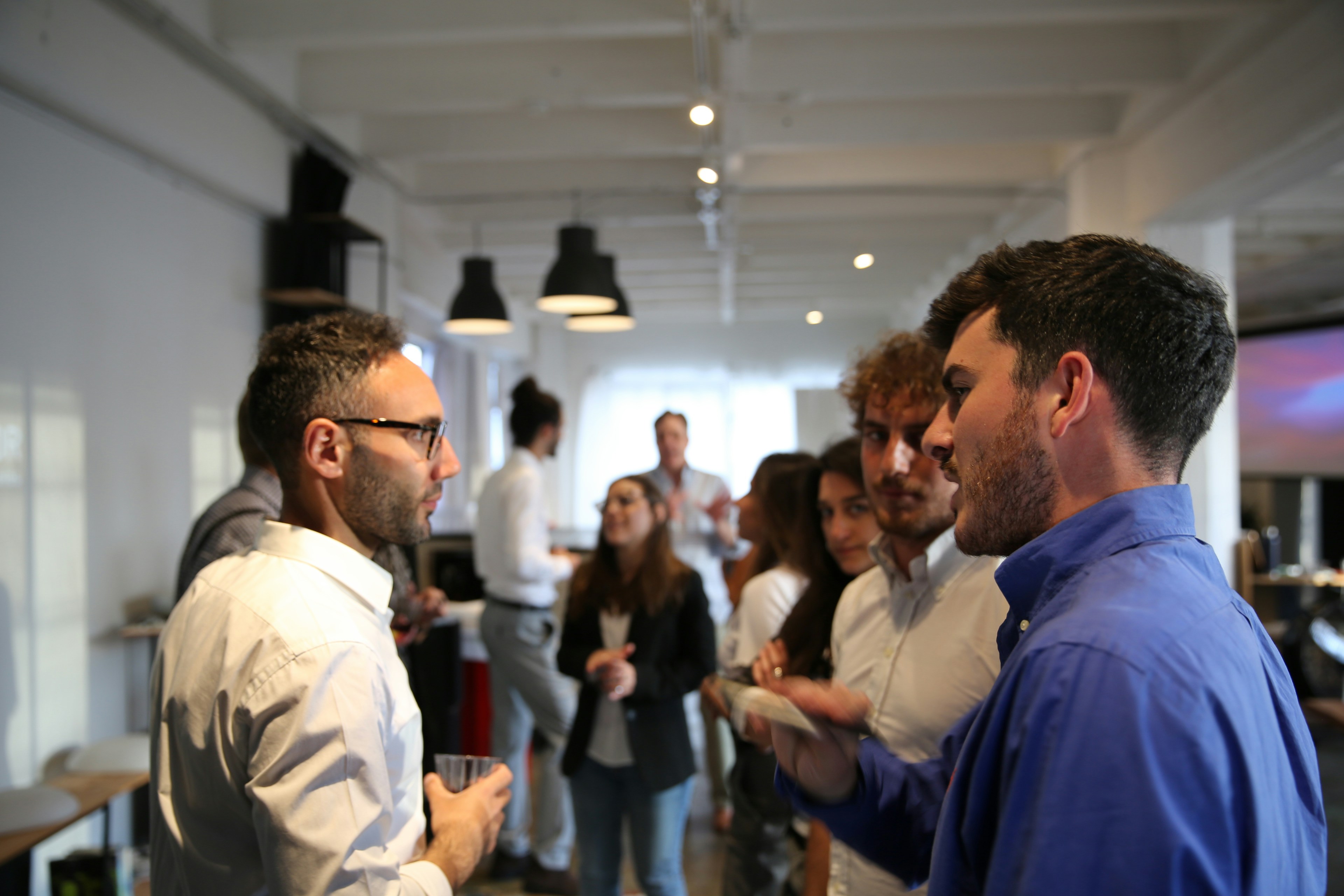 A group of people standing in a room.
