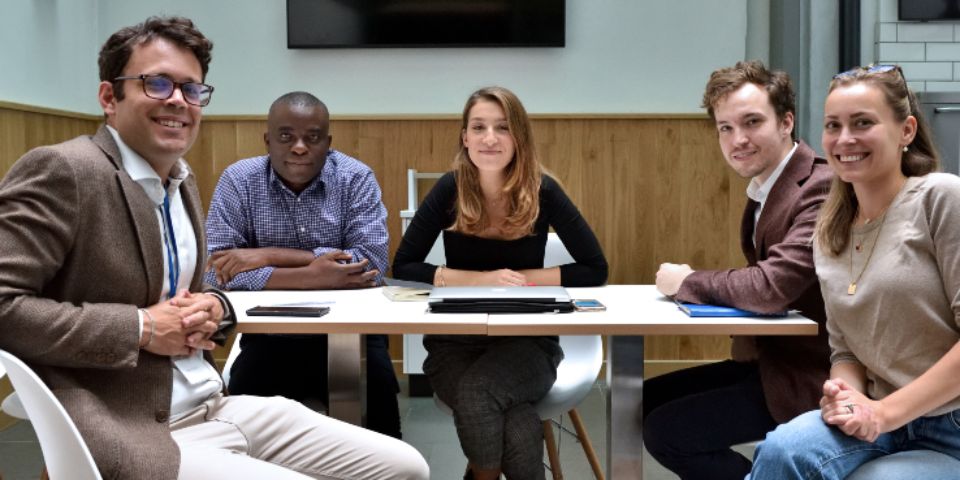 A group of researchers around a seminar table.